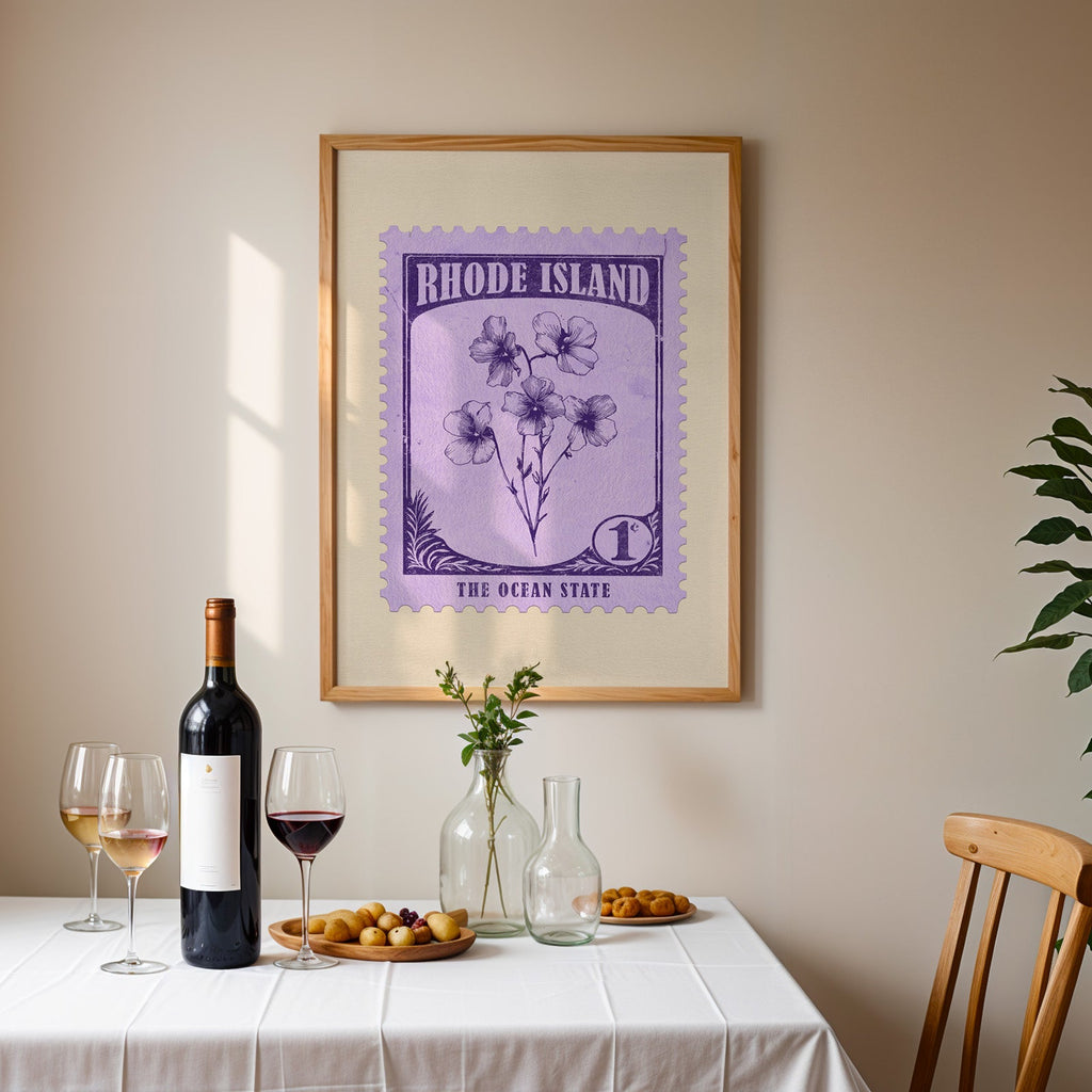 Rhode Island stamp print framed on the wall above a dining table set with wine, glasses and olives