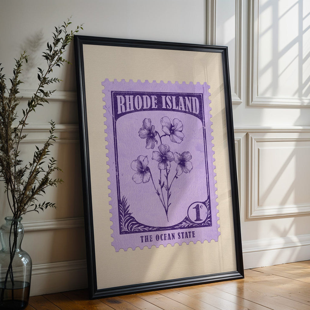 Rhode Island state flower print in a black frame leaning against a white panelled wall beside olive branches