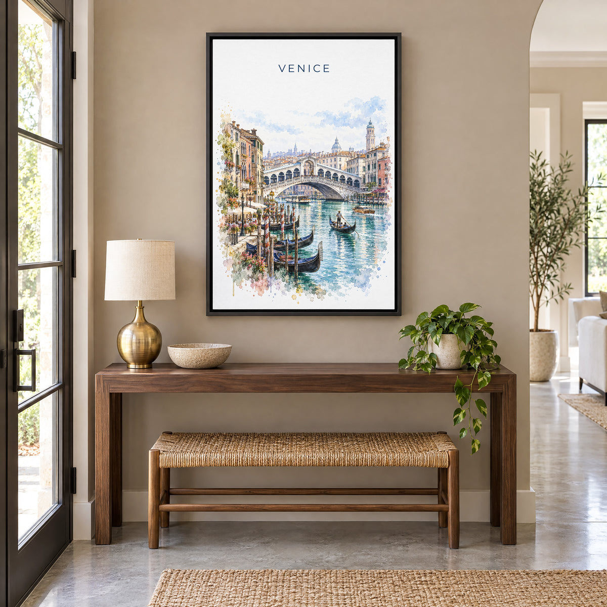 Rialto Bridge watercolor print as a black floater canvas above a walnut console and woven bench in an entryway