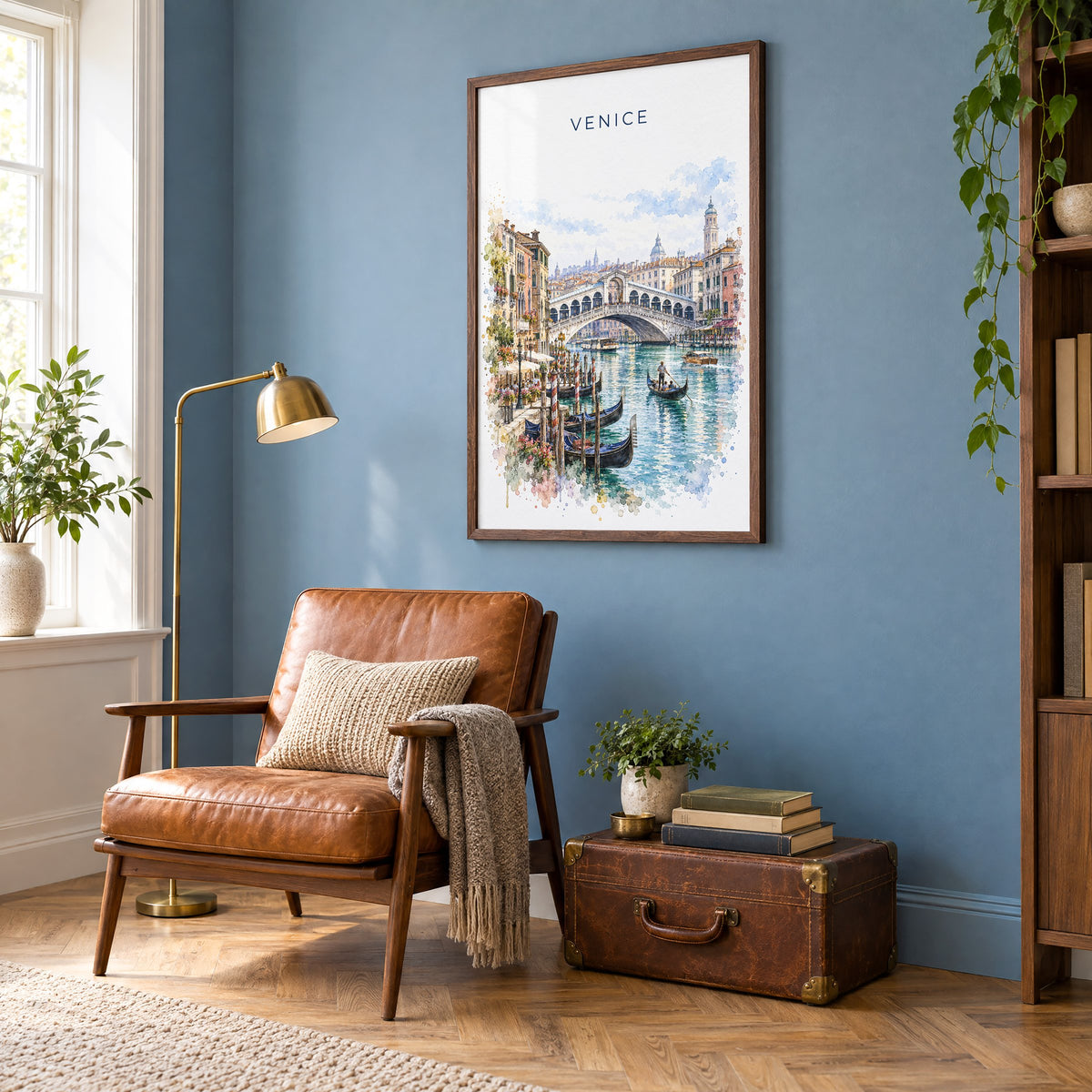 Rialto Bridge watercolor print in a walnut frame on a blue wall above a leather armchair in a reading nook