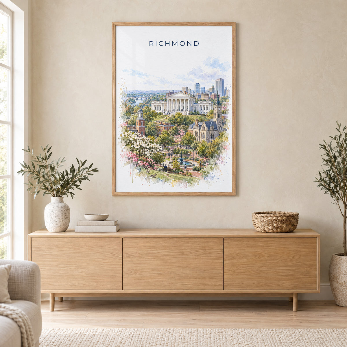 Richmond, Virginia watercolor print in an oak frame above a light wood sideboard in a Scandinavian living room