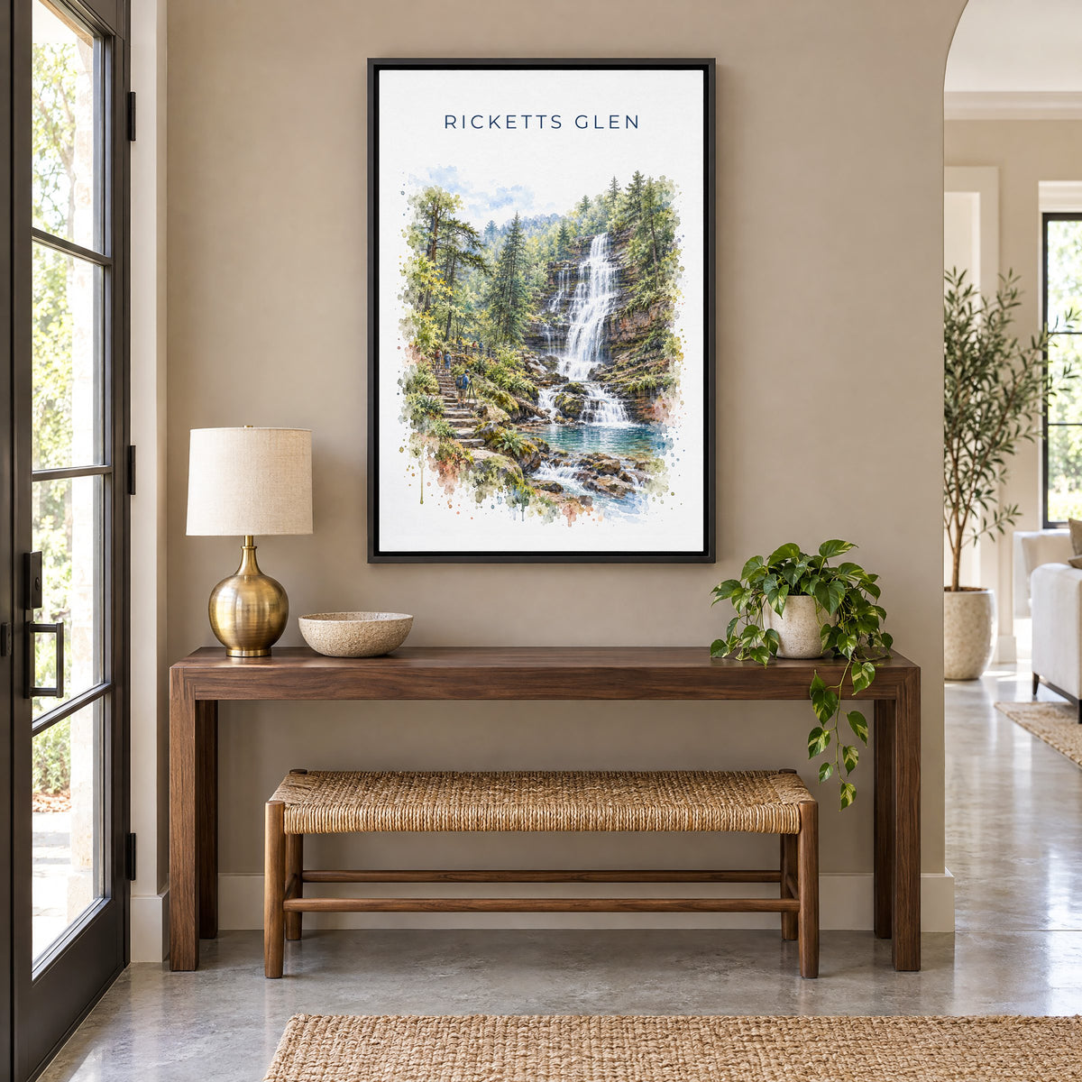 Ricketts Glen State Park watercolor print as a black floater canvas above a walnut console and woven bench in an entryway