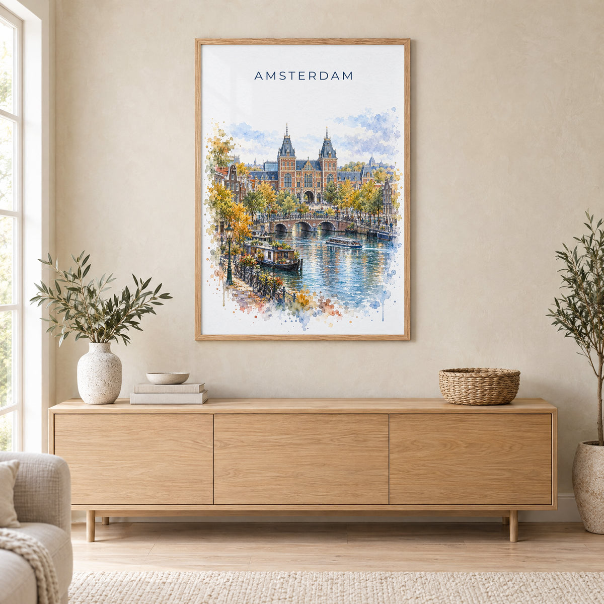 Rijksmuseum watercolor print in an oak frame above a light wood sideboard in a Scandinavian living room