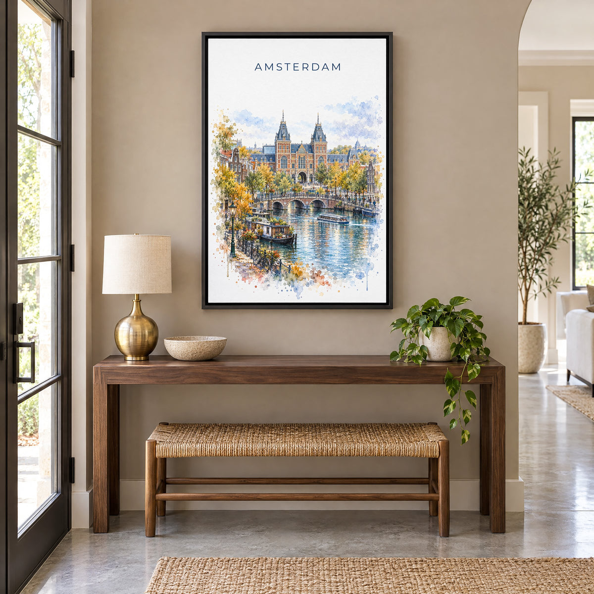 Rijksmuseum watercolor print as a black floater canvas above a walnut console and woven bench in an entryway