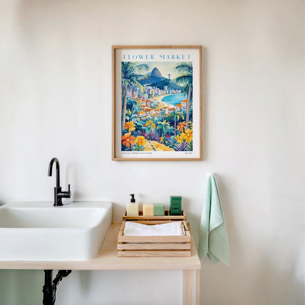 Rio de Janeiro flower market print in an oak frame above a white bathroom sink with folded towels