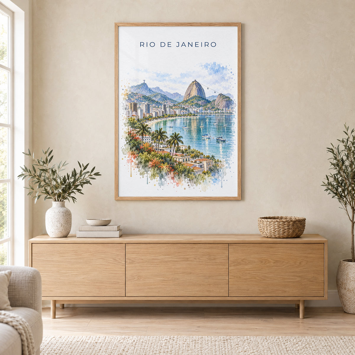 Rio de Janeiro watercolor print in an oak frame above a light wood sideboard in a Scandinavian living room