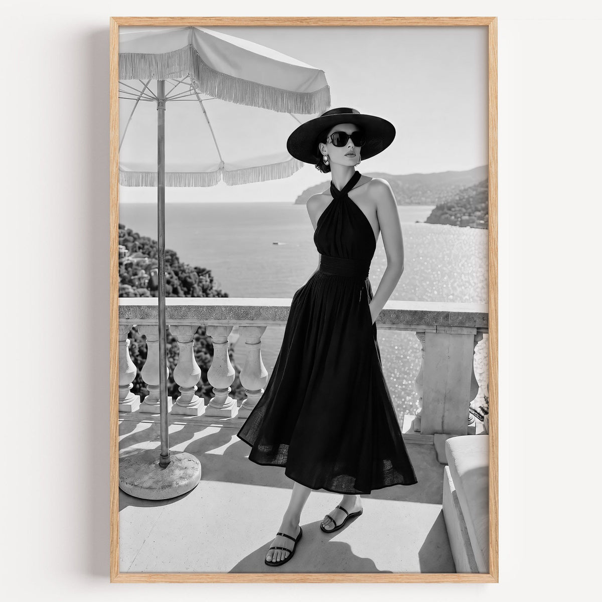 Black and white woman in halter dress on terrace print in a light oak frame on a plain white wall