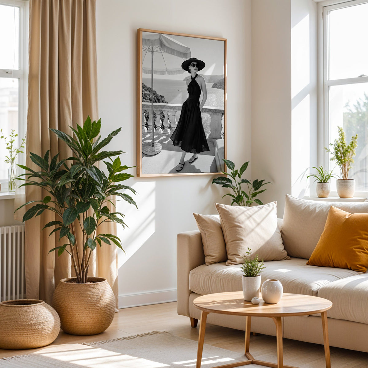 Black and white woman in halter dress on terrace print in an oak frame above a cream sofa beside woven planters