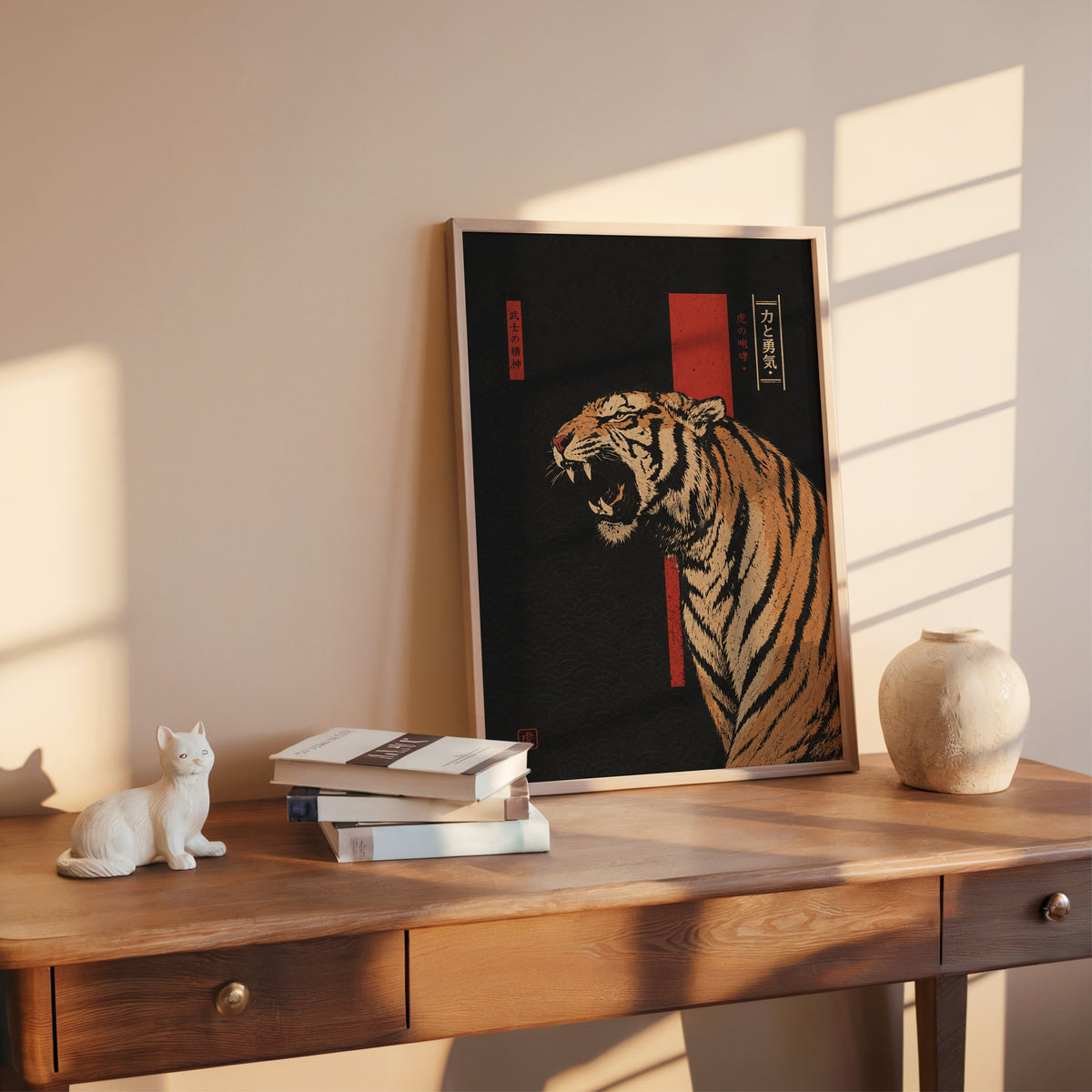 roaring tiger on black with red banner print shown in a rose gold frame leaning on a wooden writing desk with books