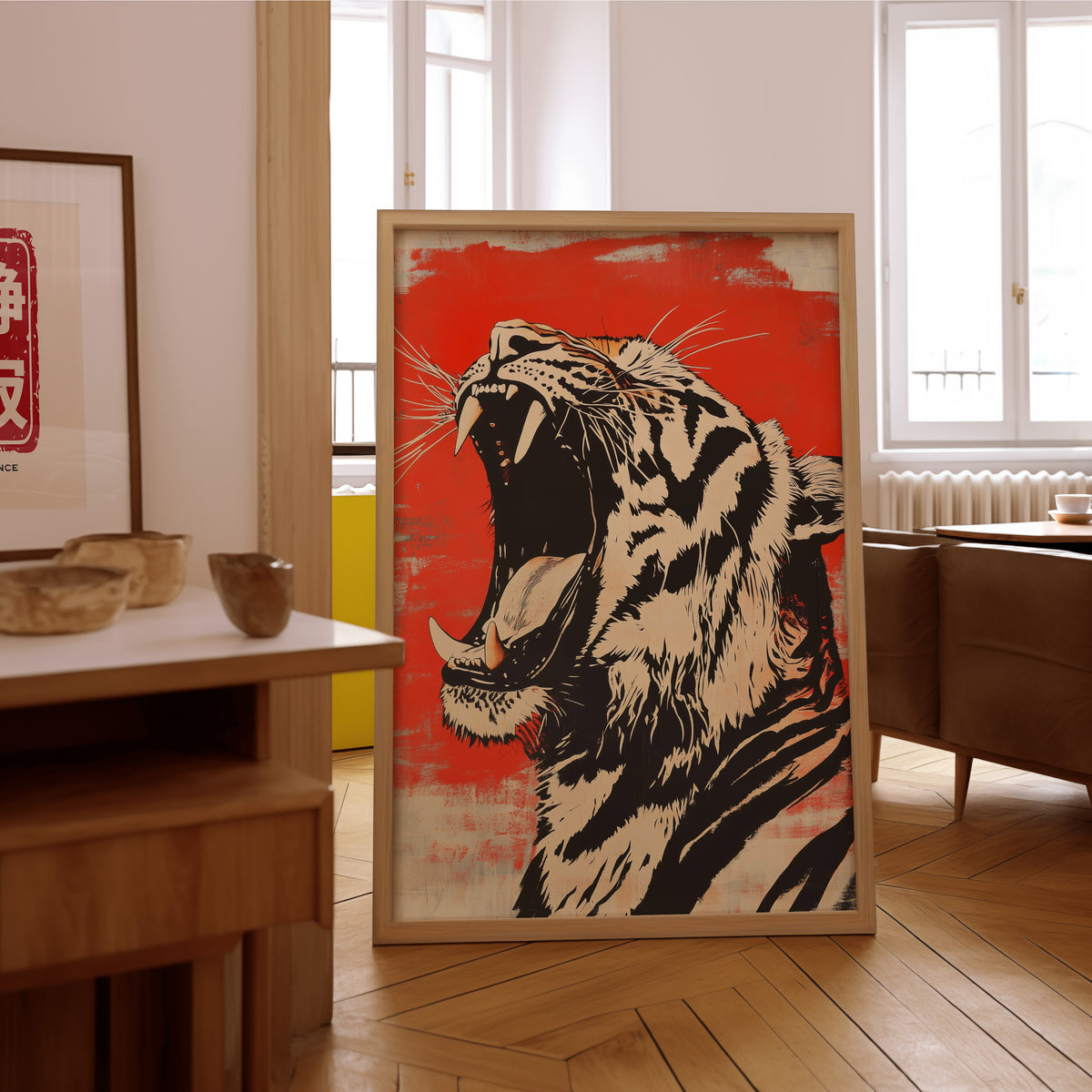 Roaring tiger head in profile print in an oak frame on the parquet floor of a sunlit living room