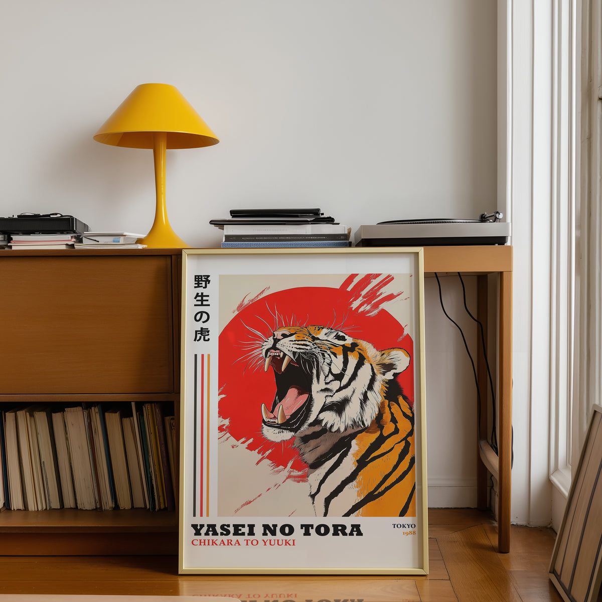 Roaring tiger with red sun print shown in a gold frame below a teak desk with a yellow lamp