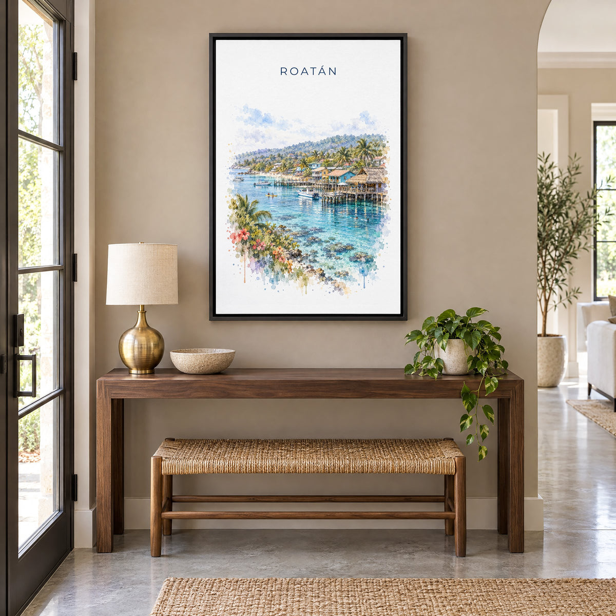 Roatan watercolor print as a black floater canvas above a walnut console and woven bench in an entryway