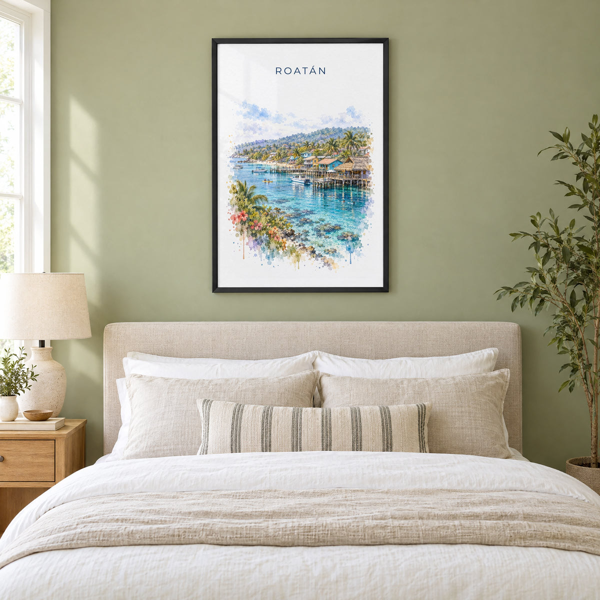 Roatan watercolor print in a black frame above an upholstered headboard in a sage green bedroom
