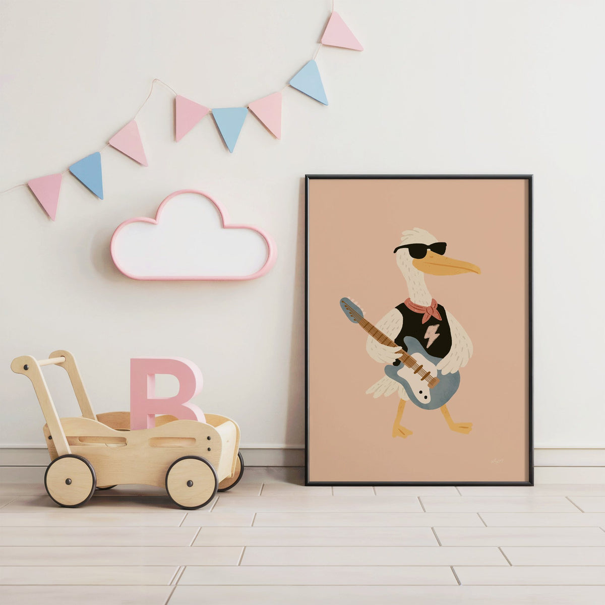 Pelican playing electric guitar nursery print in a black frame under pastel bunting by a wooden baby walker