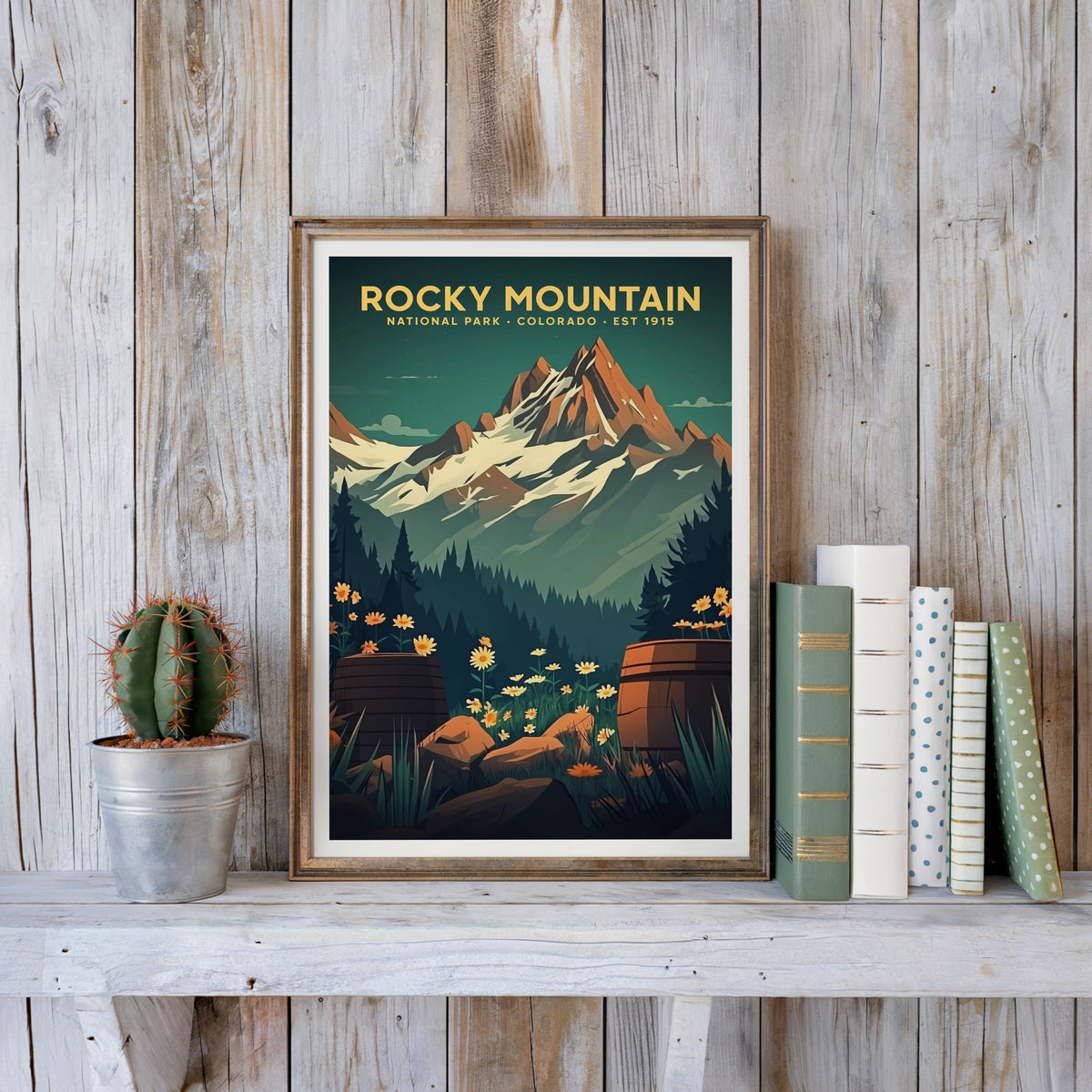 Rocky Mountain poster in an antique gold frame against whitewashed farmhouse planks beside books