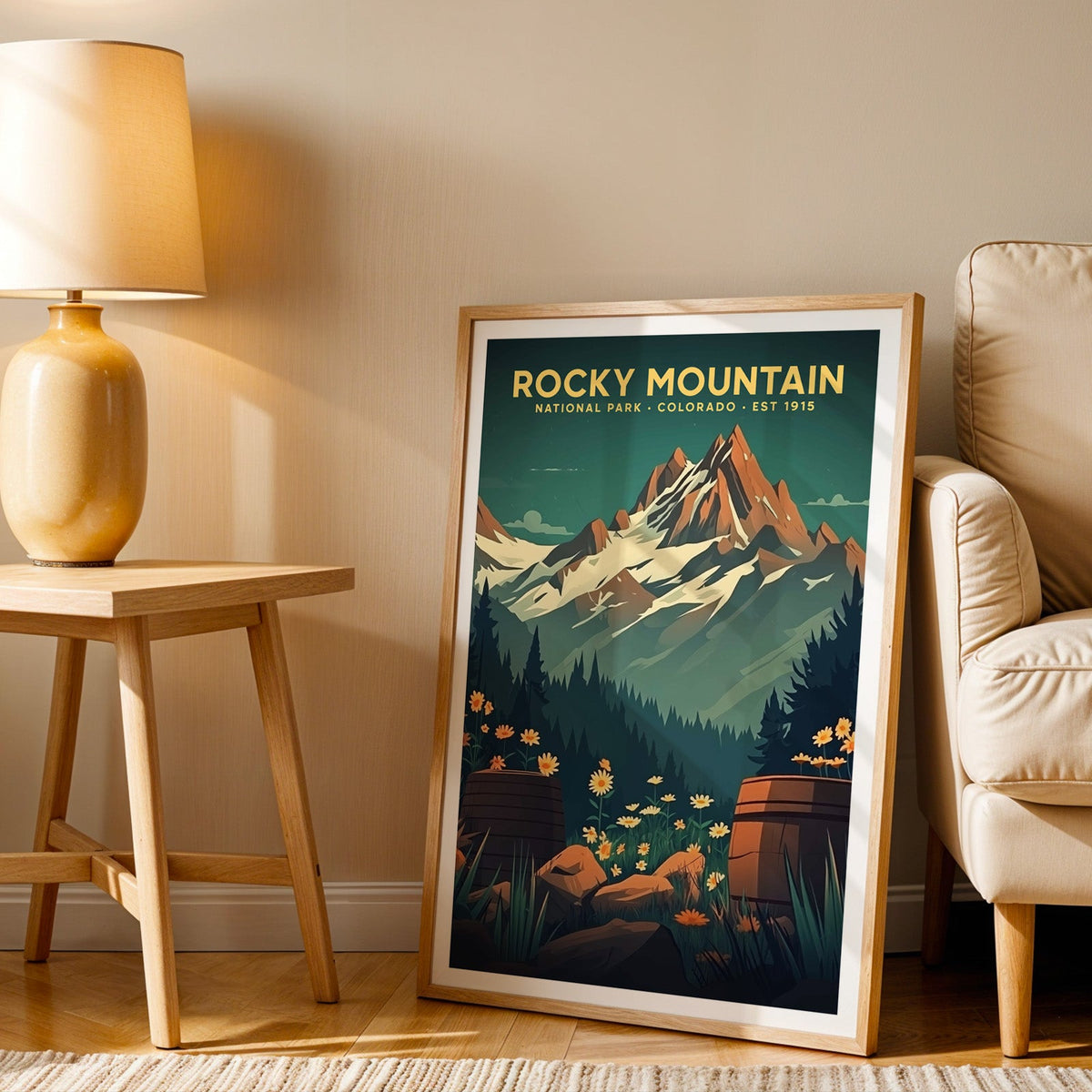 Rocky Mountain print in an oak frame beside a cream armchair and an amber lamp in warm afternoon light