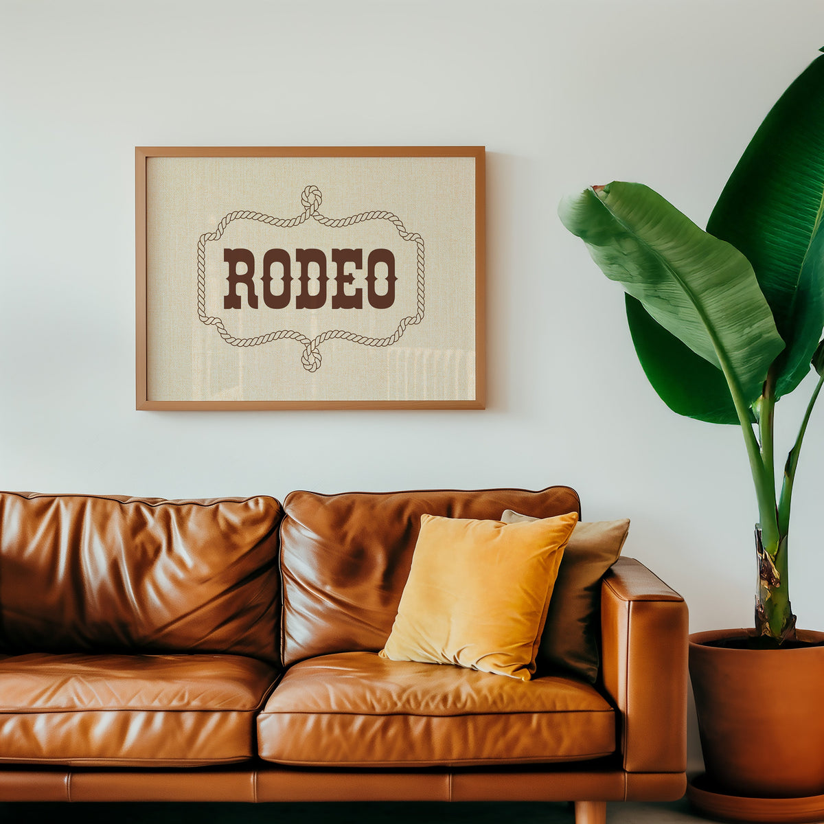 Rodeo rope frame type print in an oak frame above a cognac leather sofa