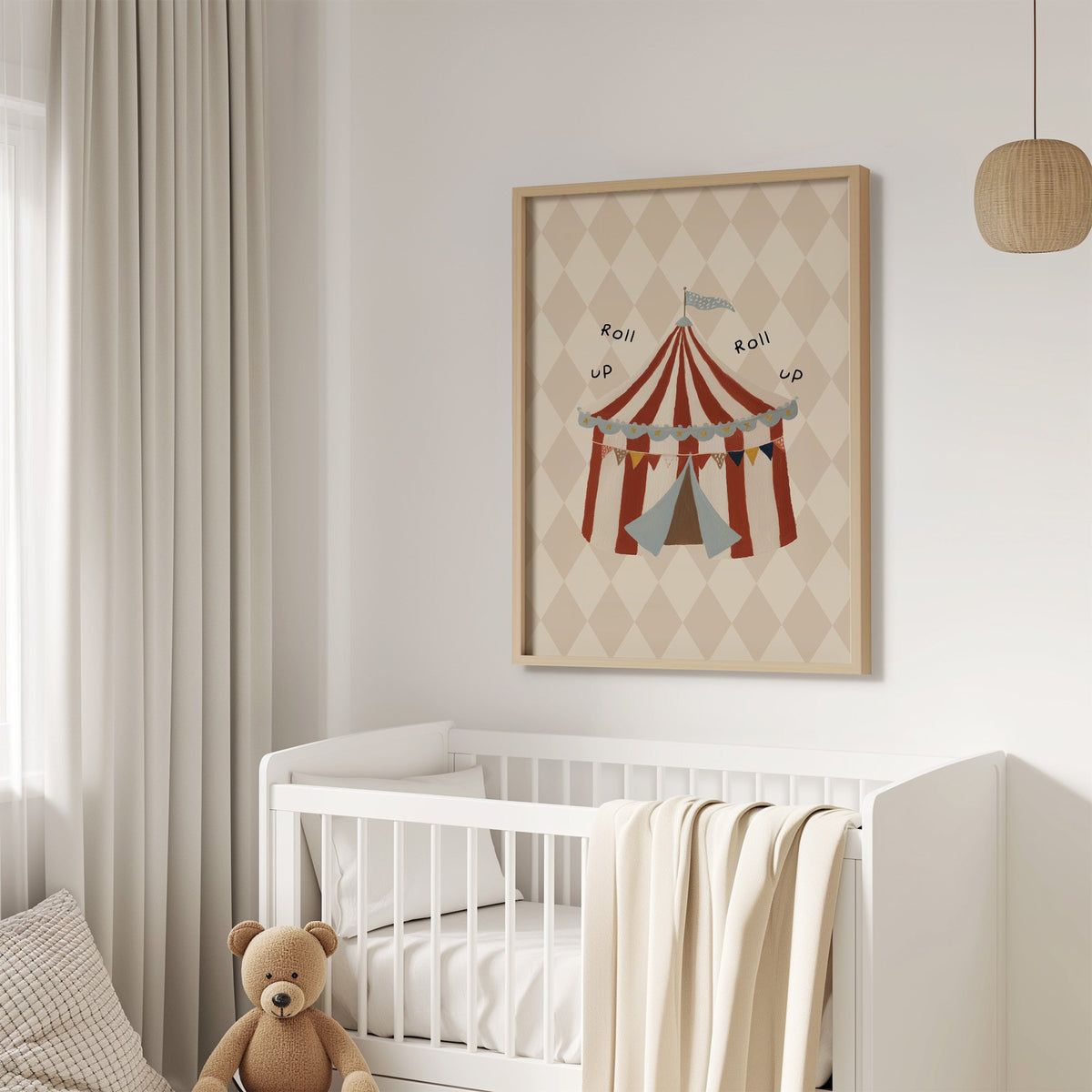 Roll up circus tent nursery print in an oak frame above a white crib with a teddy bear