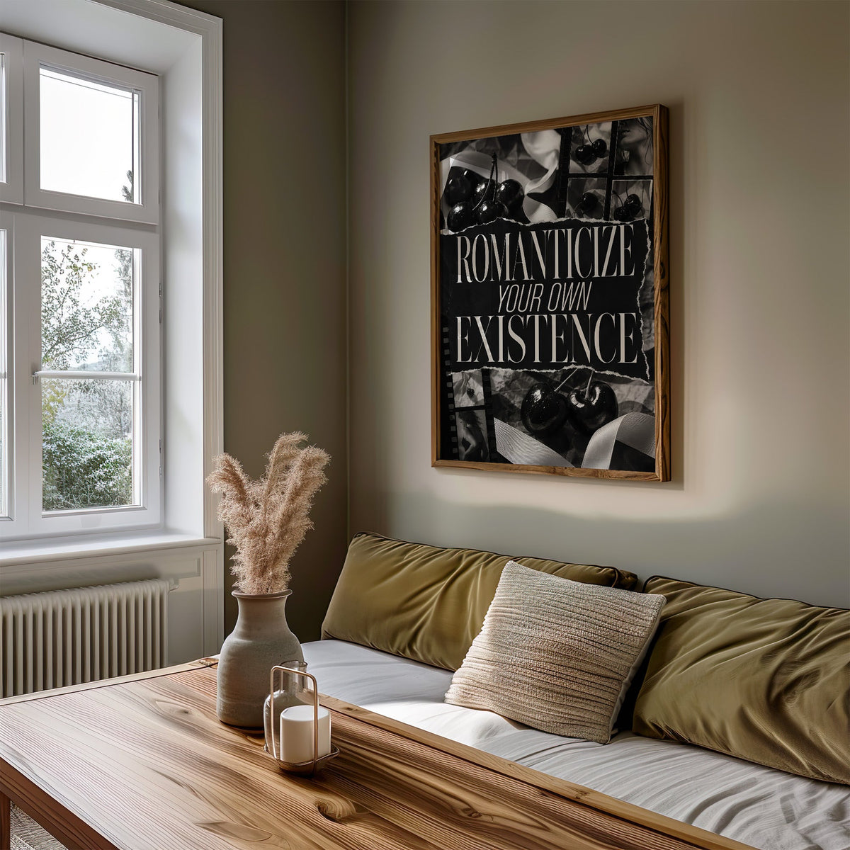 Romanticize your own existence cherry collage print in a walnut frame above an olive daybed by a window