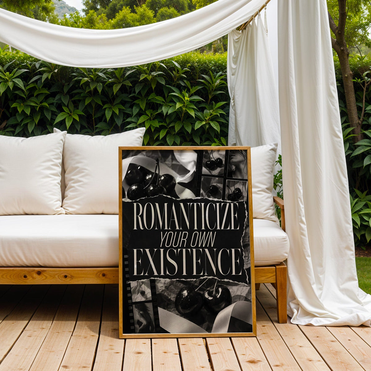 Romanticize your own existence cherry collage print in an oak frame on an outdoor daybed under white drapes