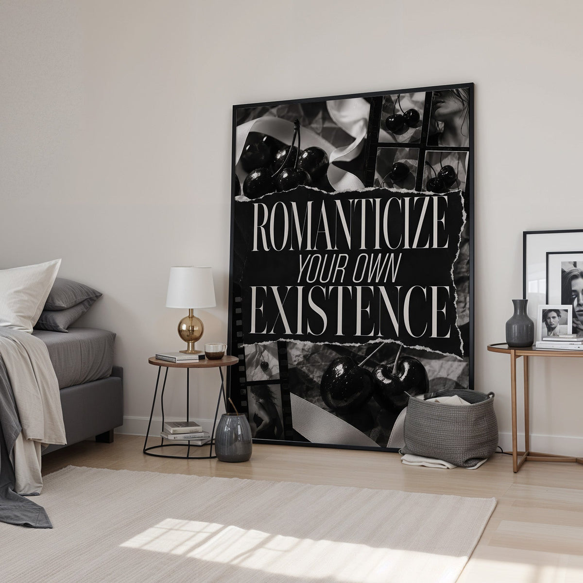 Romanticize your own existence cherry collage print in a black frame leaning in a bedroom beside a gold lamp