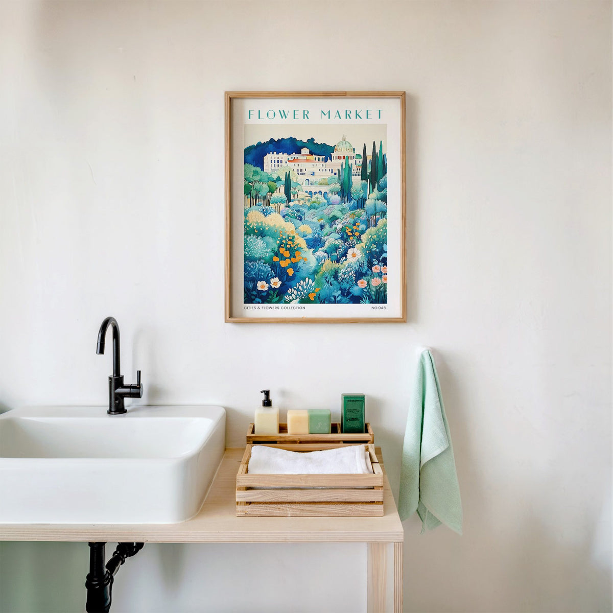 Rome flower market print in an oak frame above a white bathroom sink with folded towels