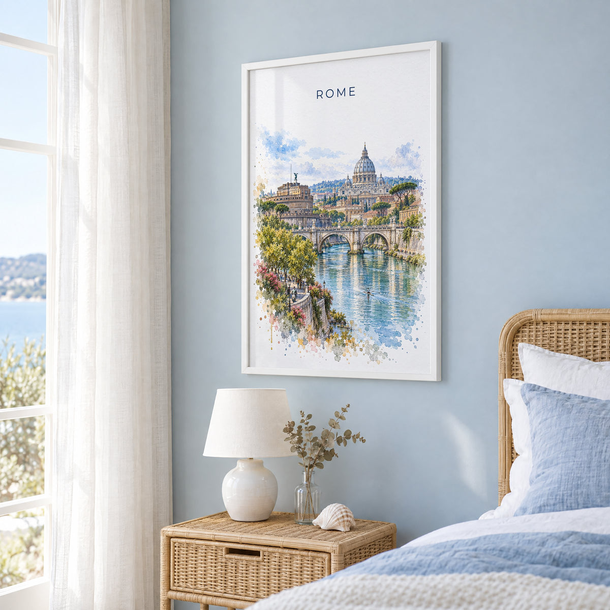Rome watercolor print in a white frame on a pale blue wall beside a rattan bed in a coastal bedroom