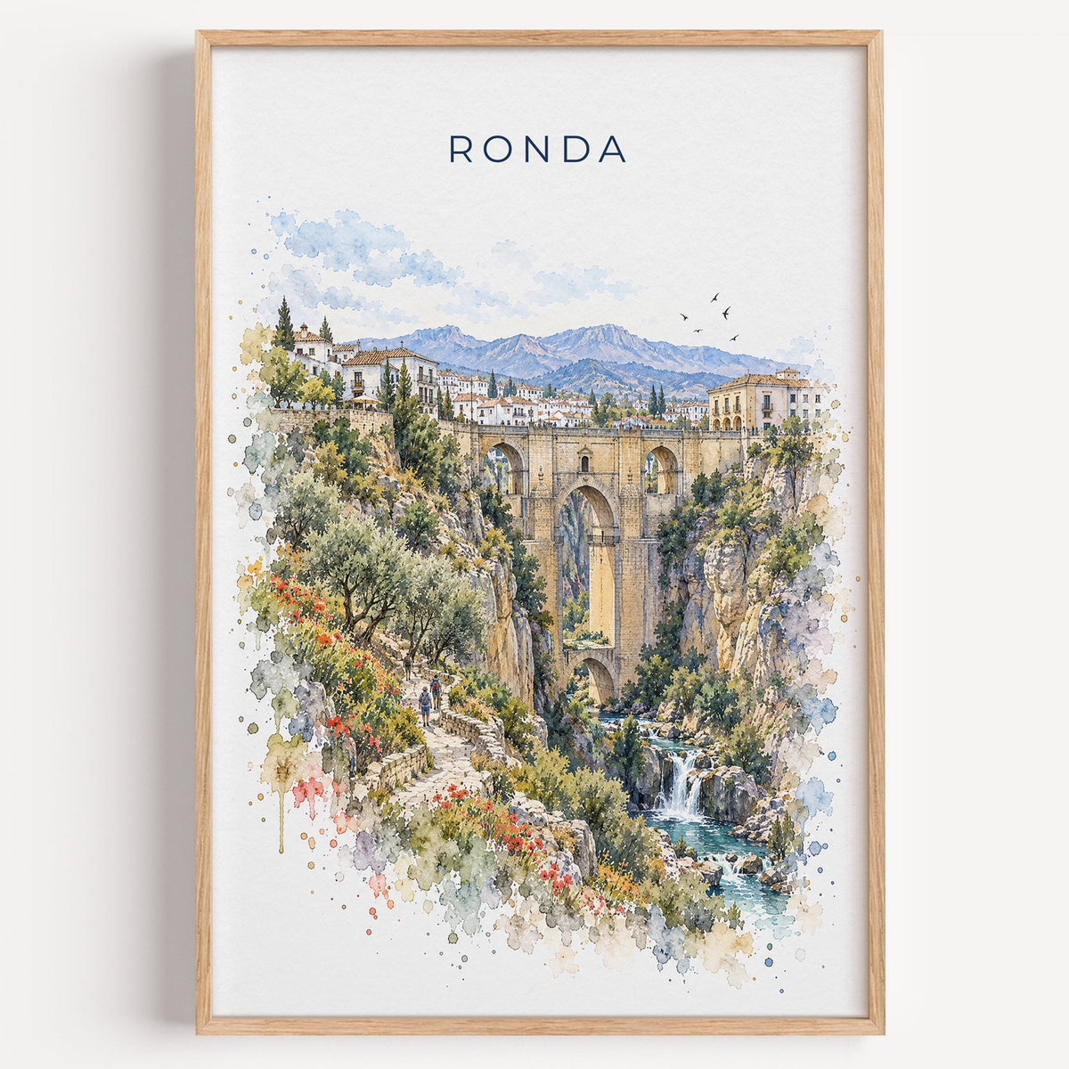 Ronda watercolor print in a light oak frame on a plain white wall