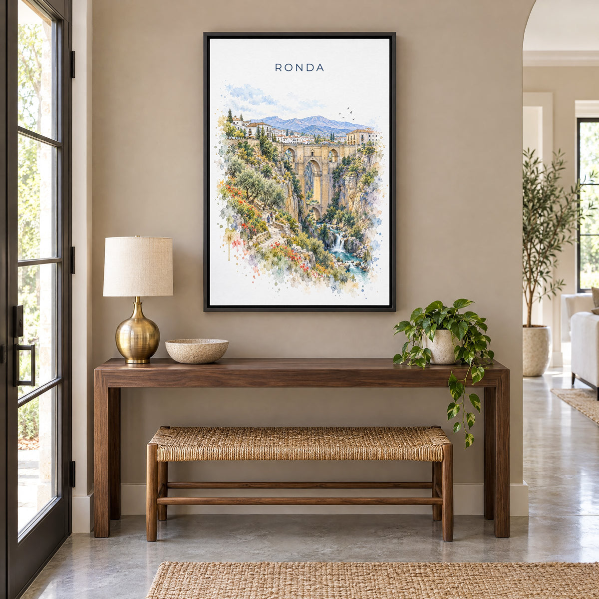 Ronda watercolor print as a black floater canvas above a walnut console and woven bench in an entryway