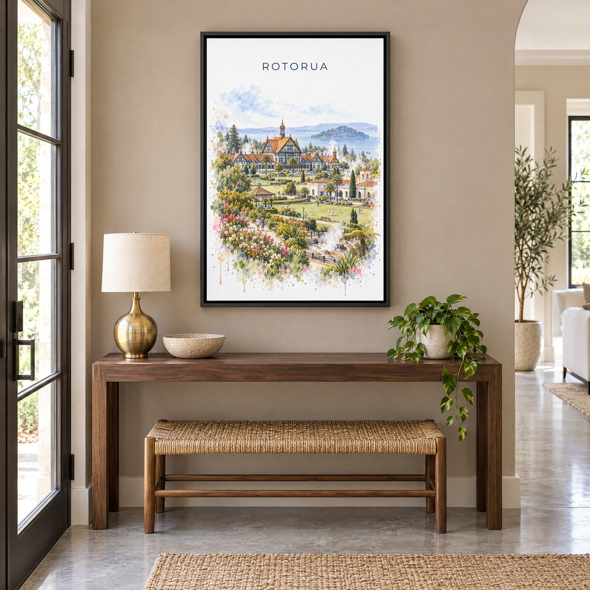 Rotorua watercolor print as a black floater canvas above a walnut console and woven bench in an entryway