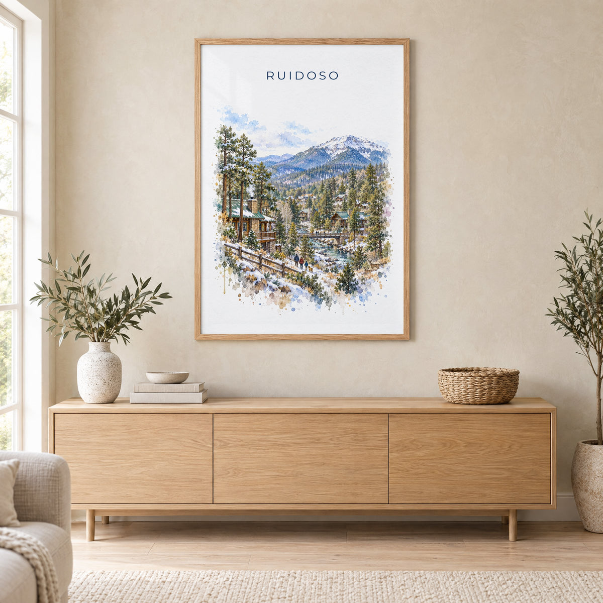 Ruidoso, New Mexico watercolor print in an oak frame above a light wood sideboard in a Scandinavian living room