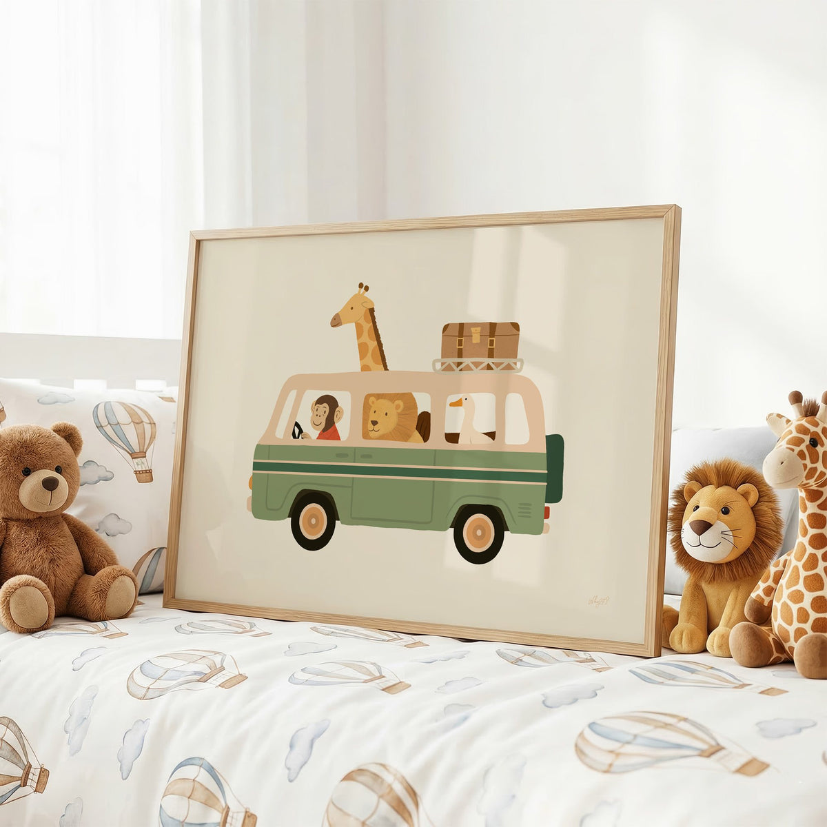 Safari animals riding green van nursery print in an oak frame on a kids bed with hot air balloon bedding