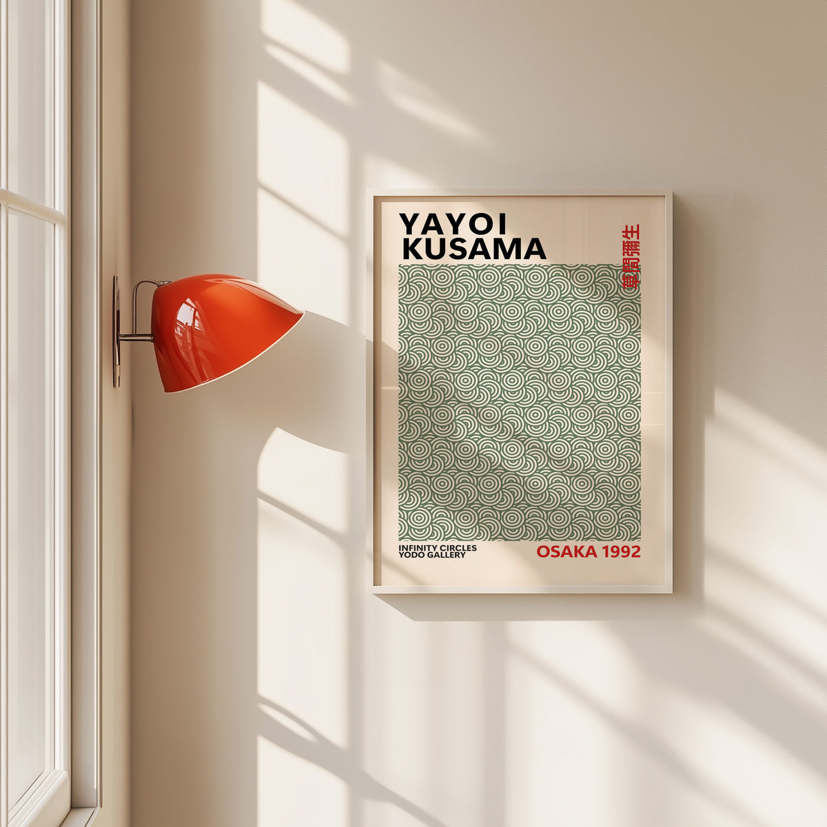 Yayoi Kusama inspired sage green circle pattern print in a white frame by a red wall lamp