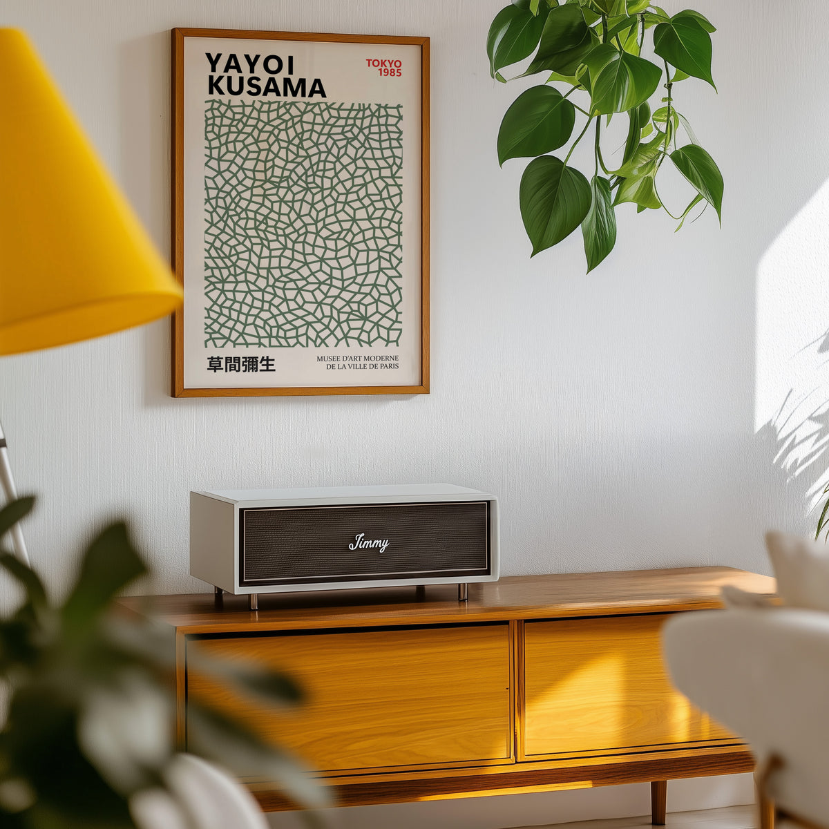 Yayoi Kusama inspired sage green net print above a sideboard with a plant