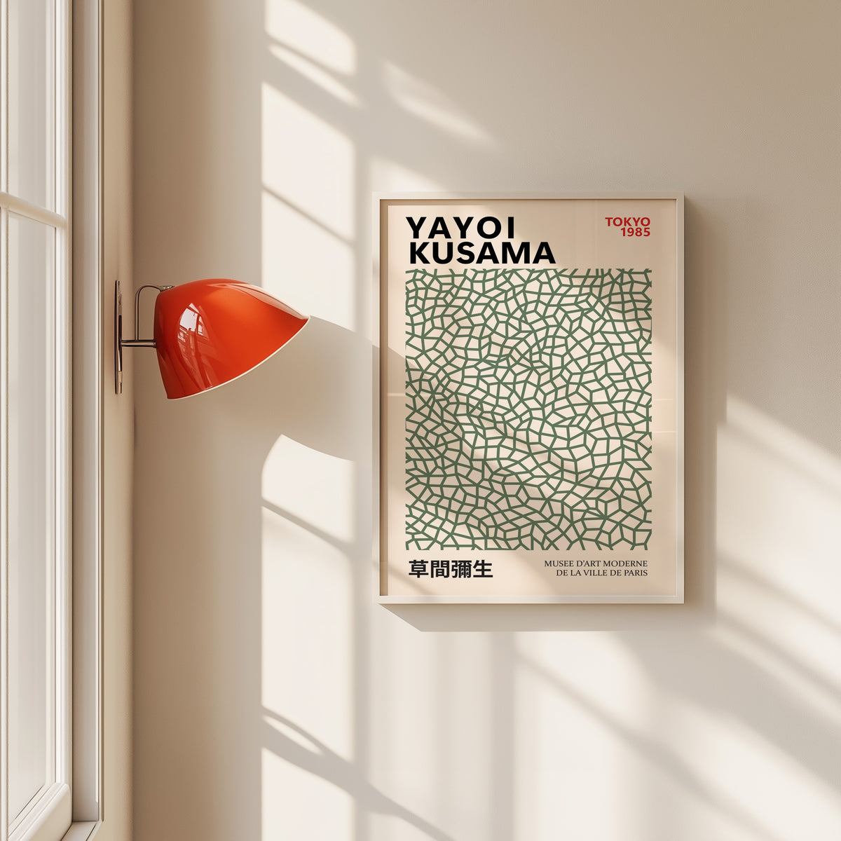 Yayoi Kusama inspired sage green net print in a white frame by a red wall lamp