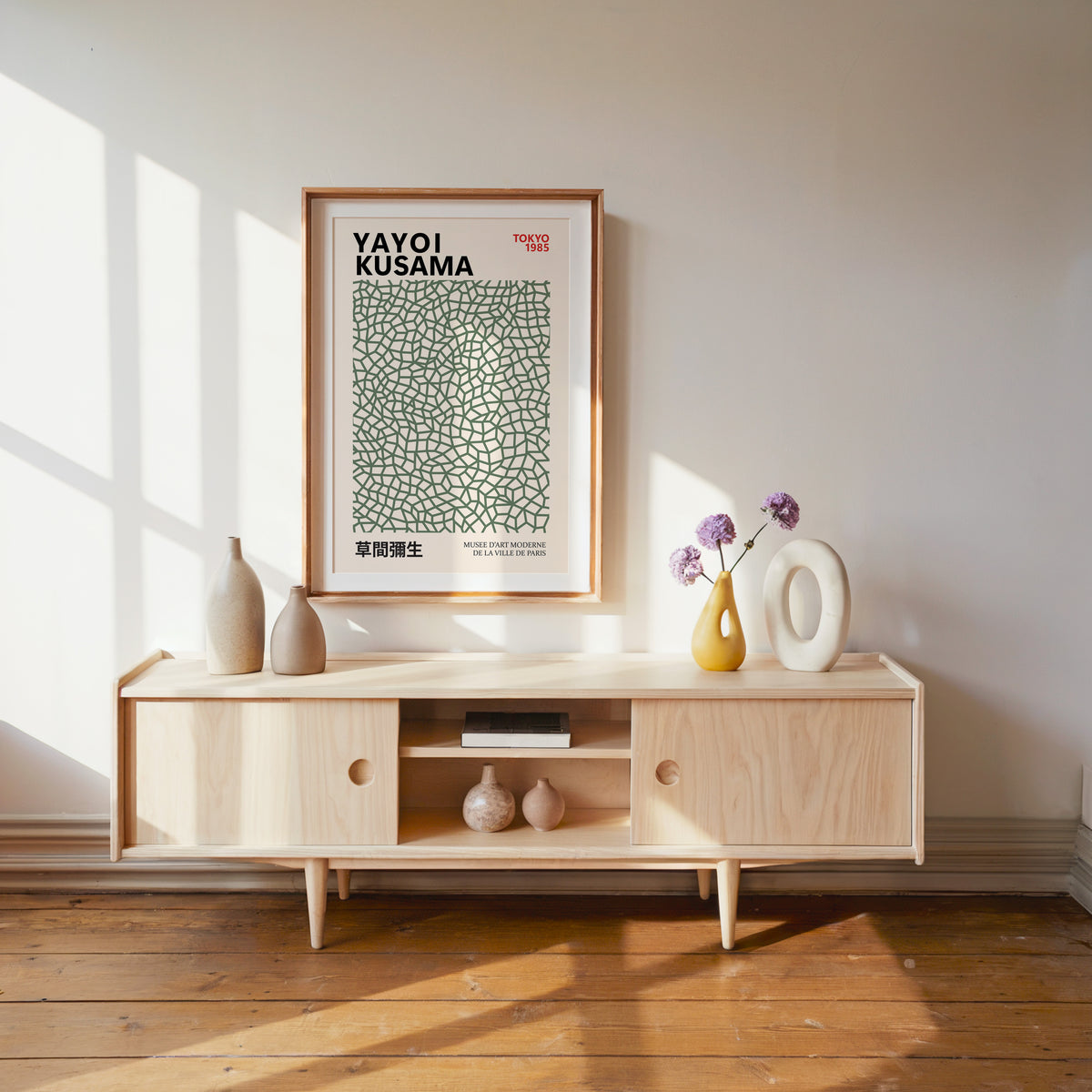 Yayoi Kusama inspired sage green net print above a pale wood console