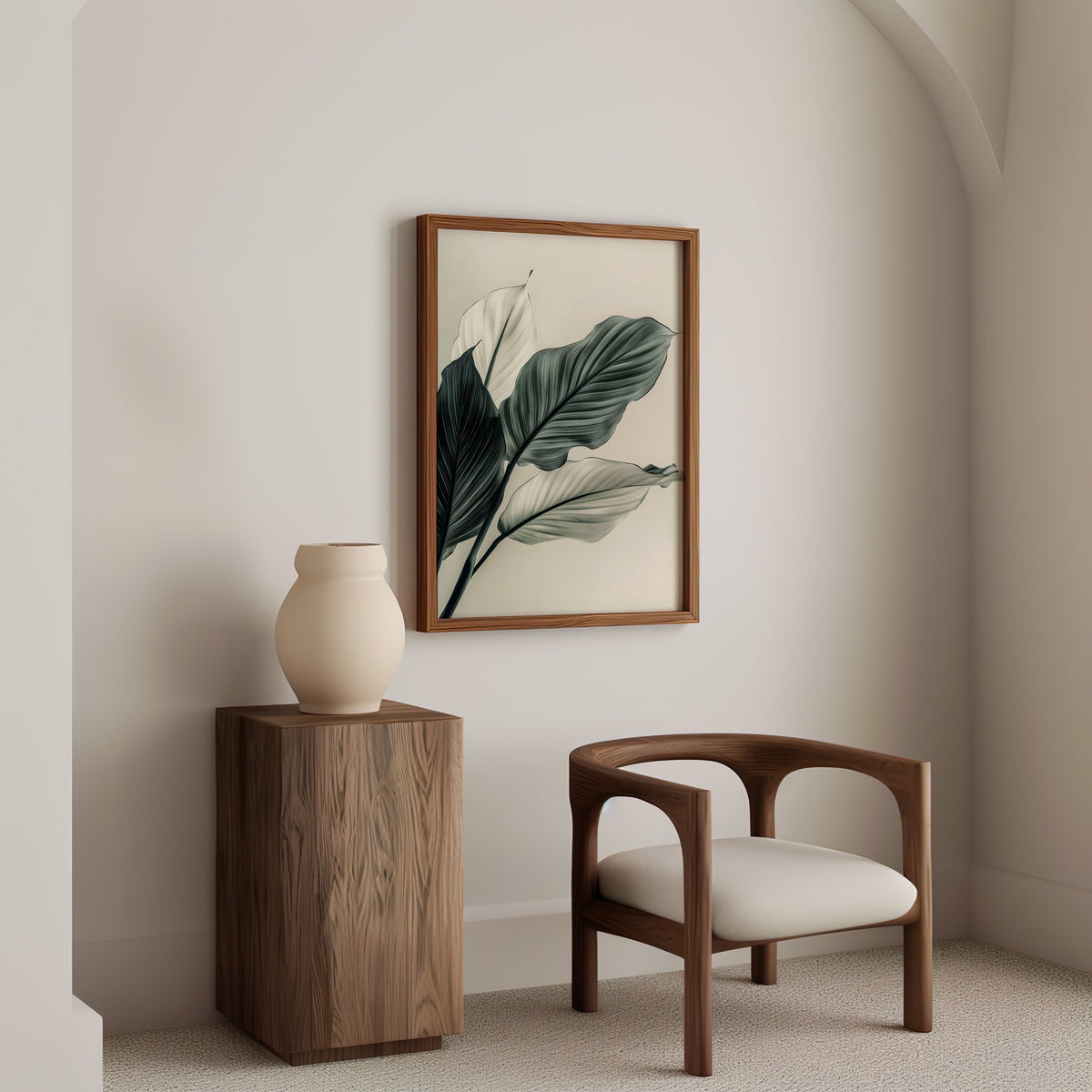 Sage green leaves abstract botanical print in a walnut frame above a wood pedestal and a curved walnut armchair