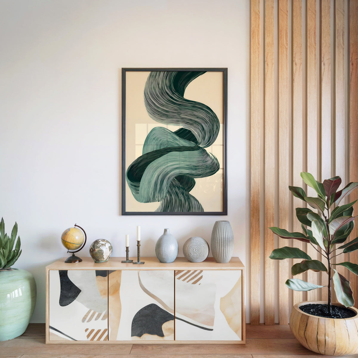 Sage green line ribbon swirl abstract print in a black frame above a light wood sideboard by a wood slat wall