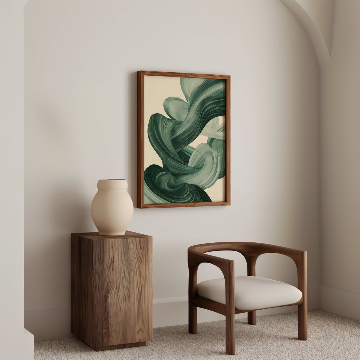 Sage green paint swirl abstract print in a walnut frame above a wood pedestal and a curved walnut armchair