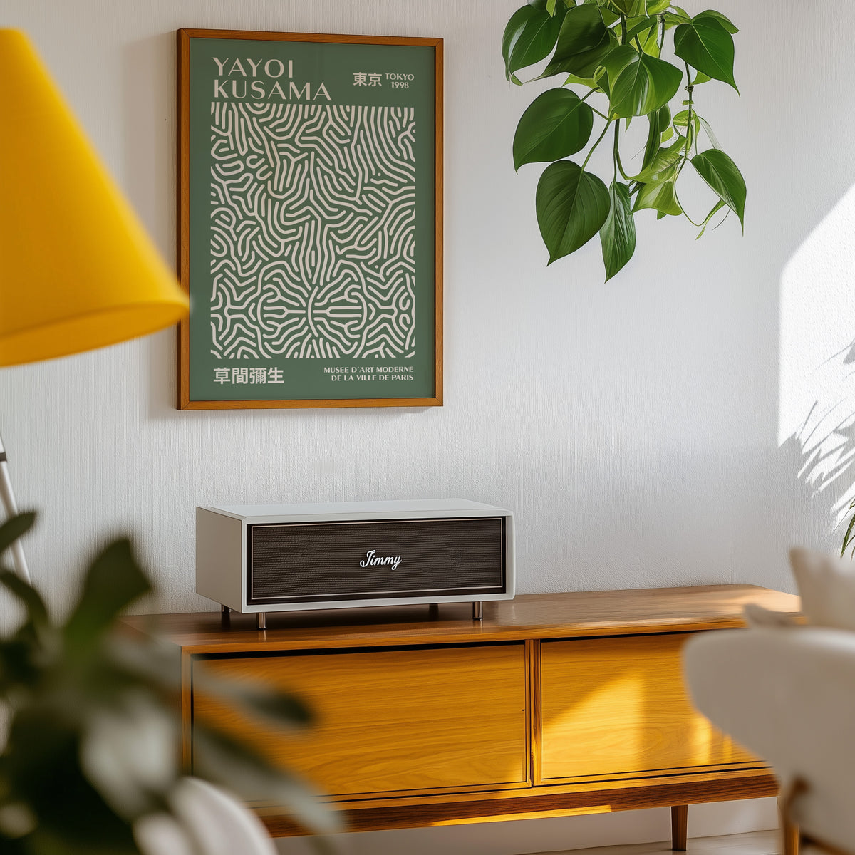 Yayoi Kusama inspired sage squiggle on deep green print above a sideboard with a plant