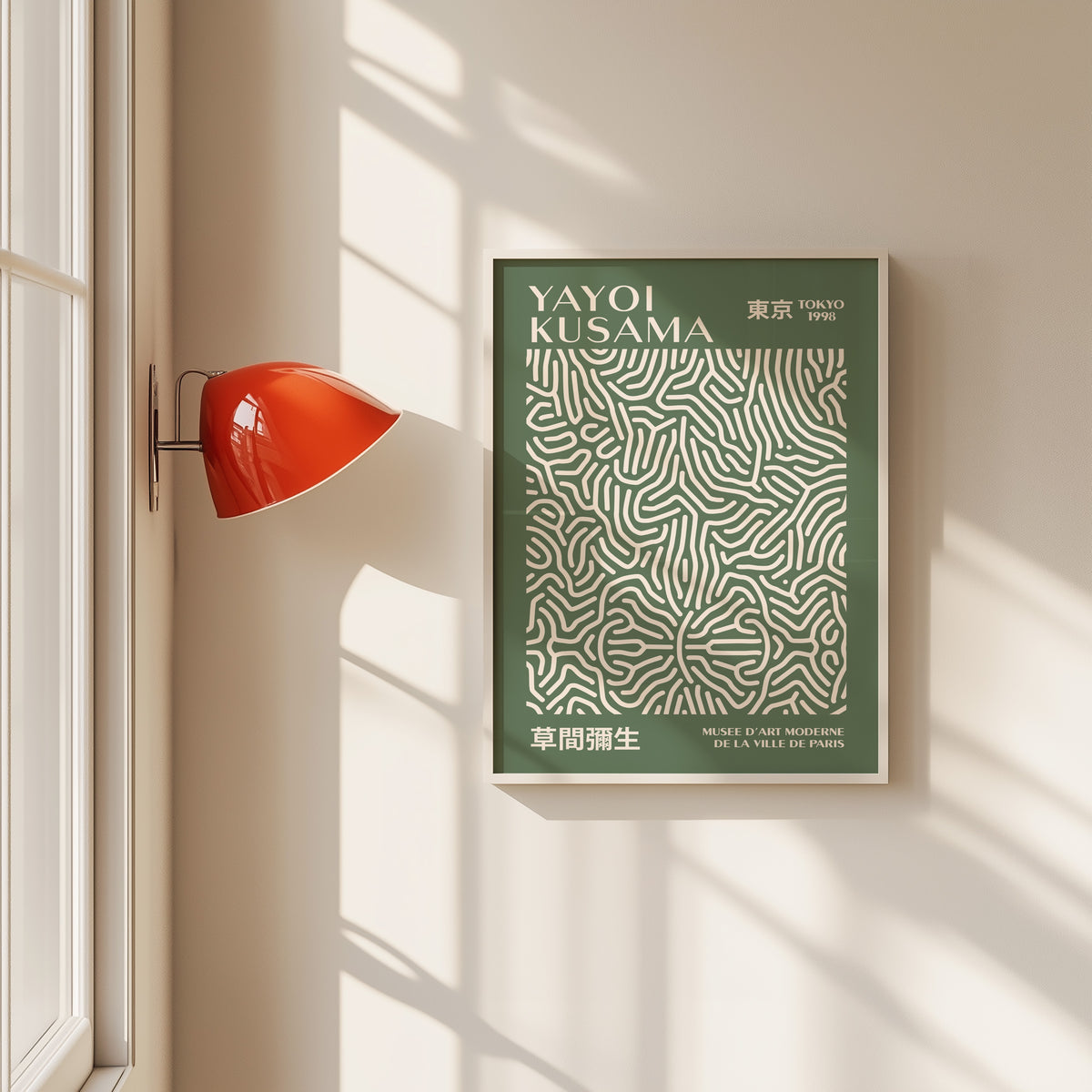 Yayoi Kusama inspired sage squiggle on deep green print in a white frame by a red wall lamp