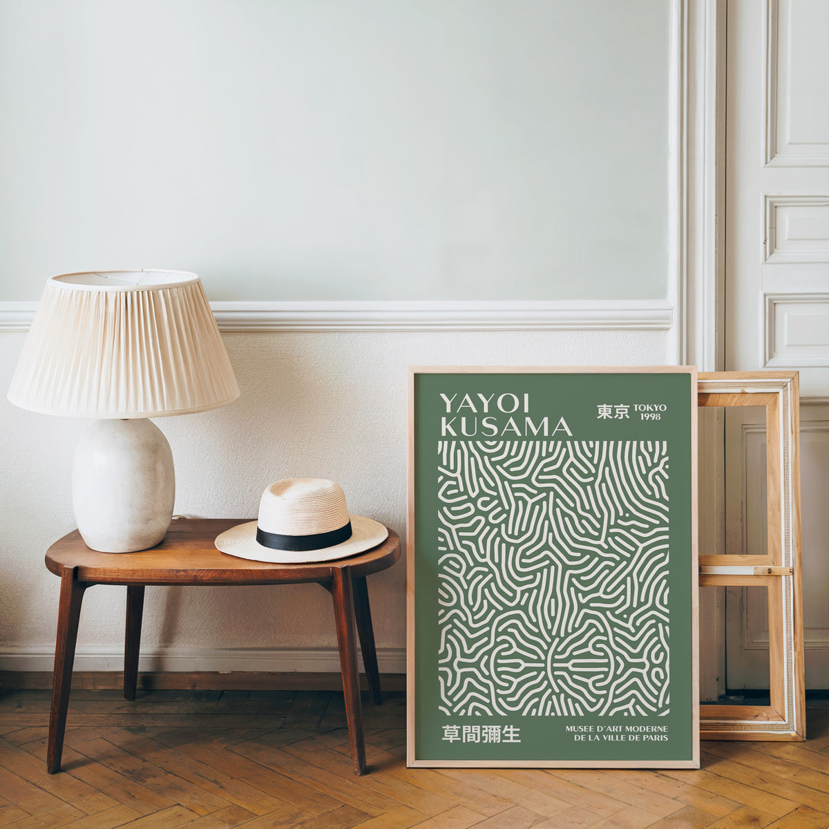 Yayoi Kusama inspired sage squiggle on deep green print beside a bench and straw hat