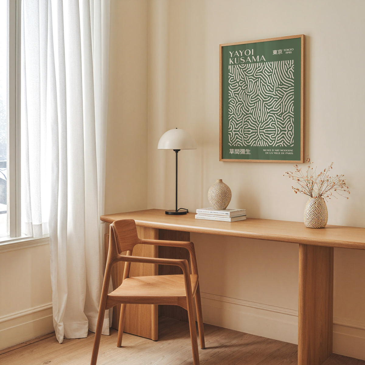 Yayoi Kusama inspired sage squiggle on deep green print above a desk with a dome lamp