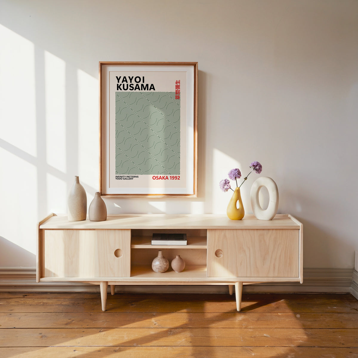 Yayoi Kusama inspired sage green swirl line print above a pale wood console