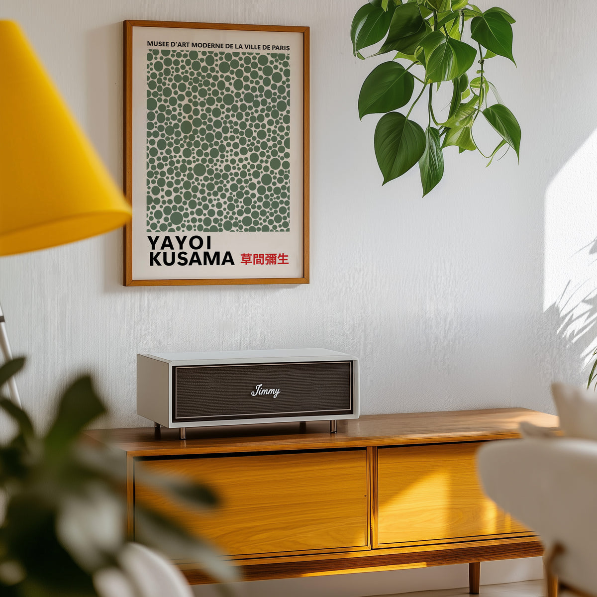 Yayoi Kusama inspired sage green polka dot print above a sideboard with a plant
