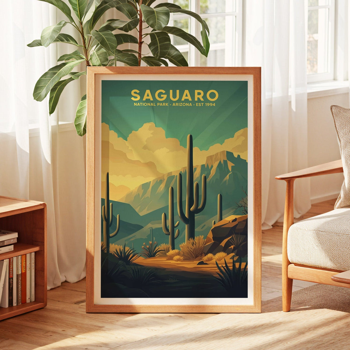 Saguaro National Park print in an oak frame by a sunlit window with sheer curtains and a fig plant