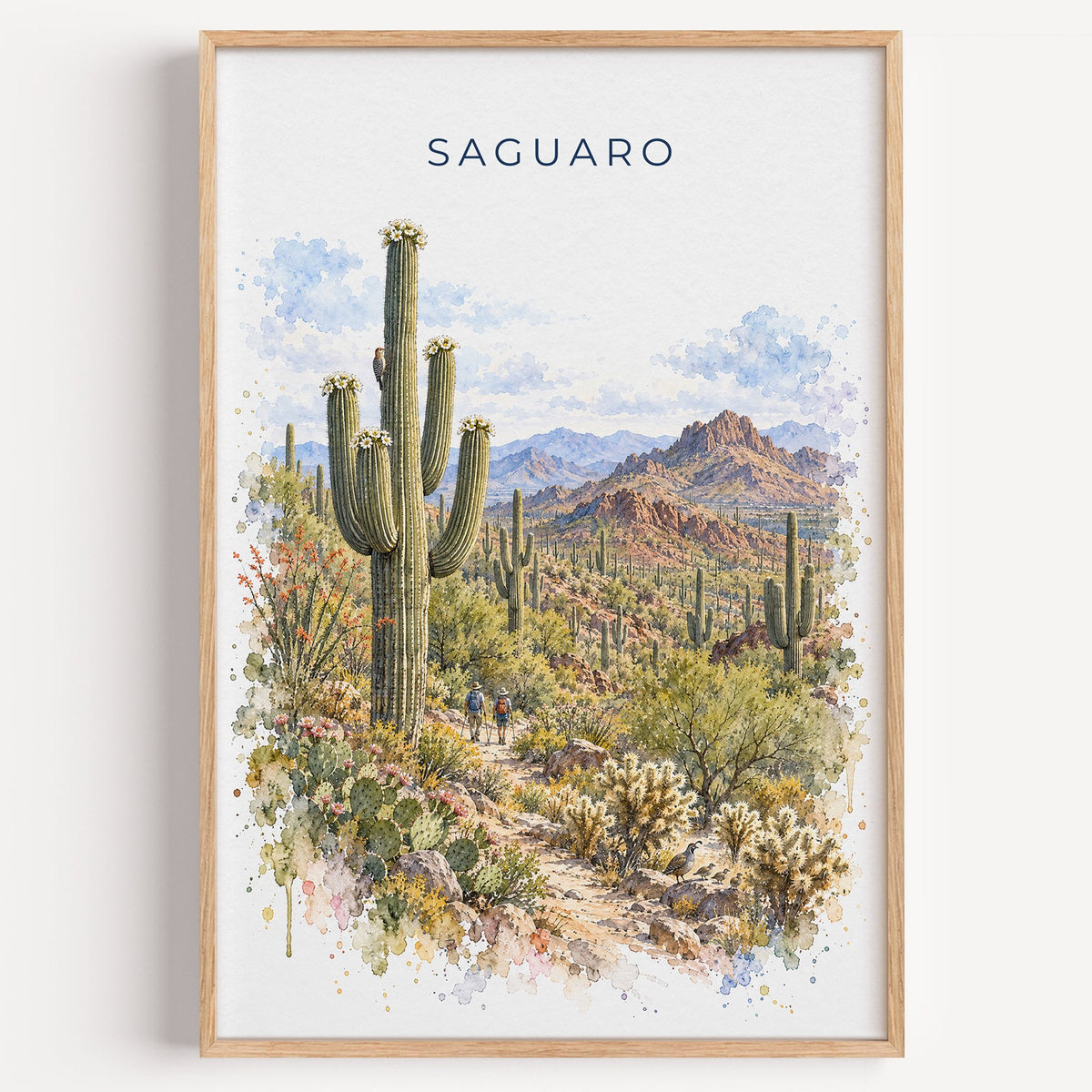 Saguaro National Park watercolor print in a light oak frame on a plain white wall