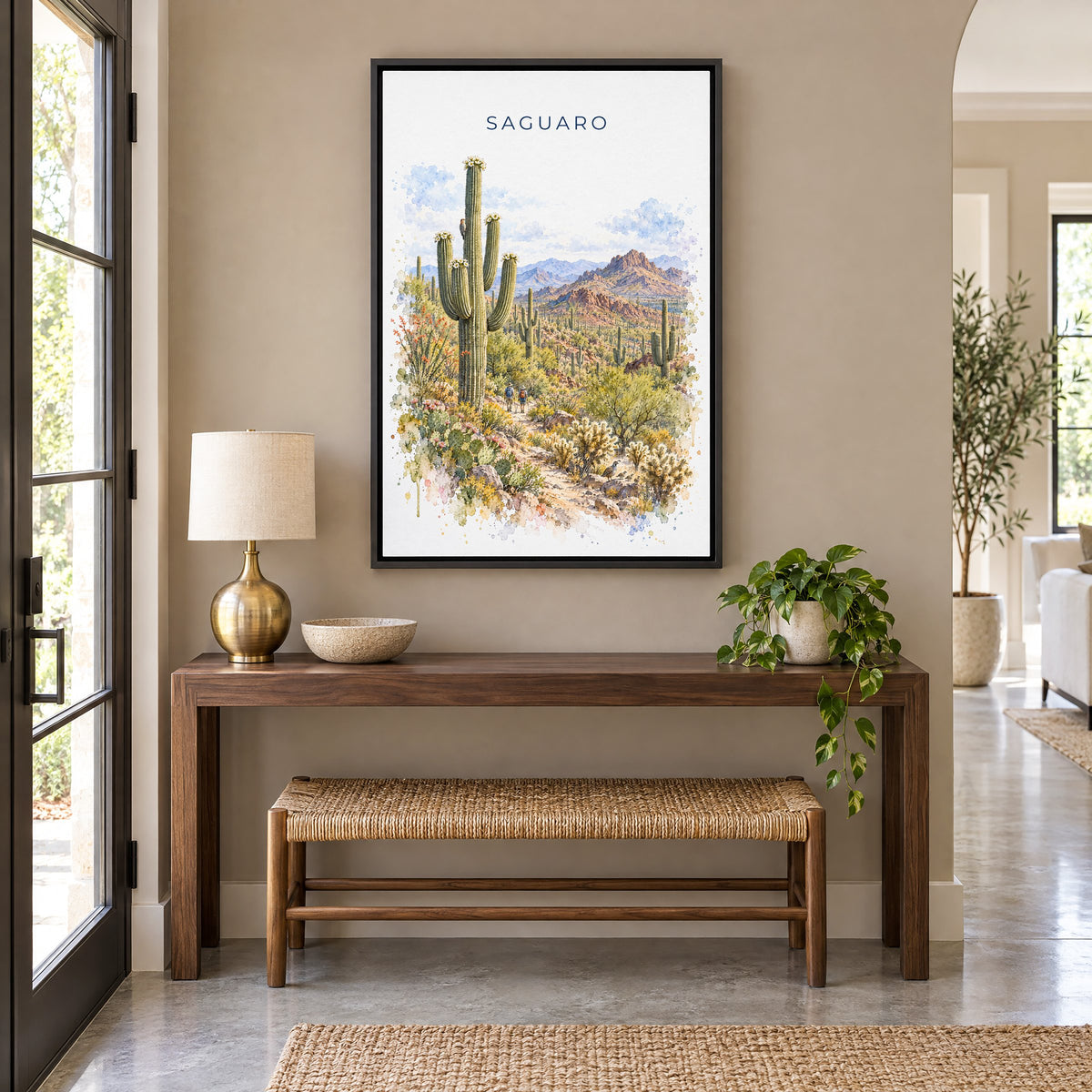 Saguaro National Park watercolor print as a black floater canvas above a walnut console and woven bench in an entryway