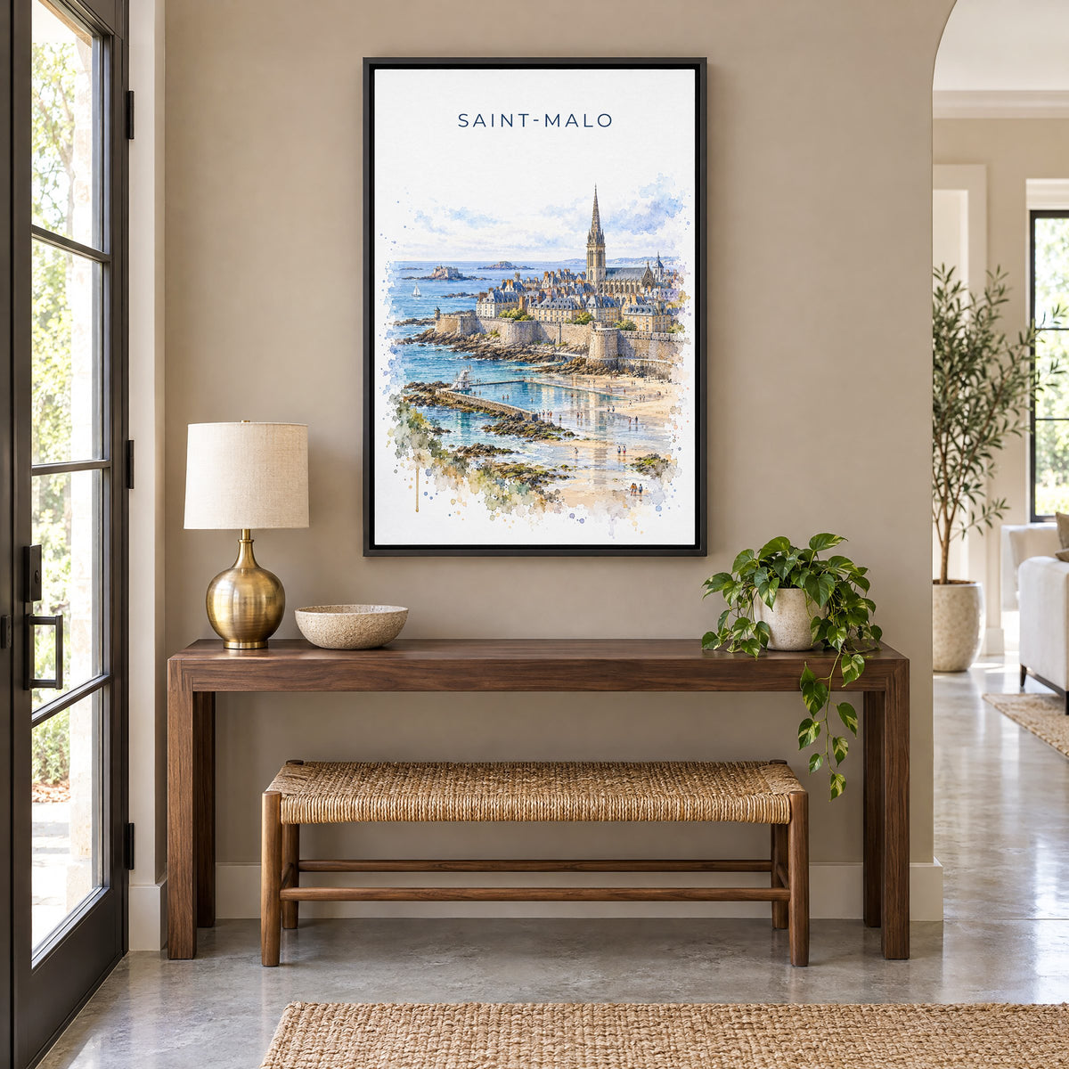 Saint-Malo watercolor print as a black floater canvas above a walnut console and woven bench in an entryway