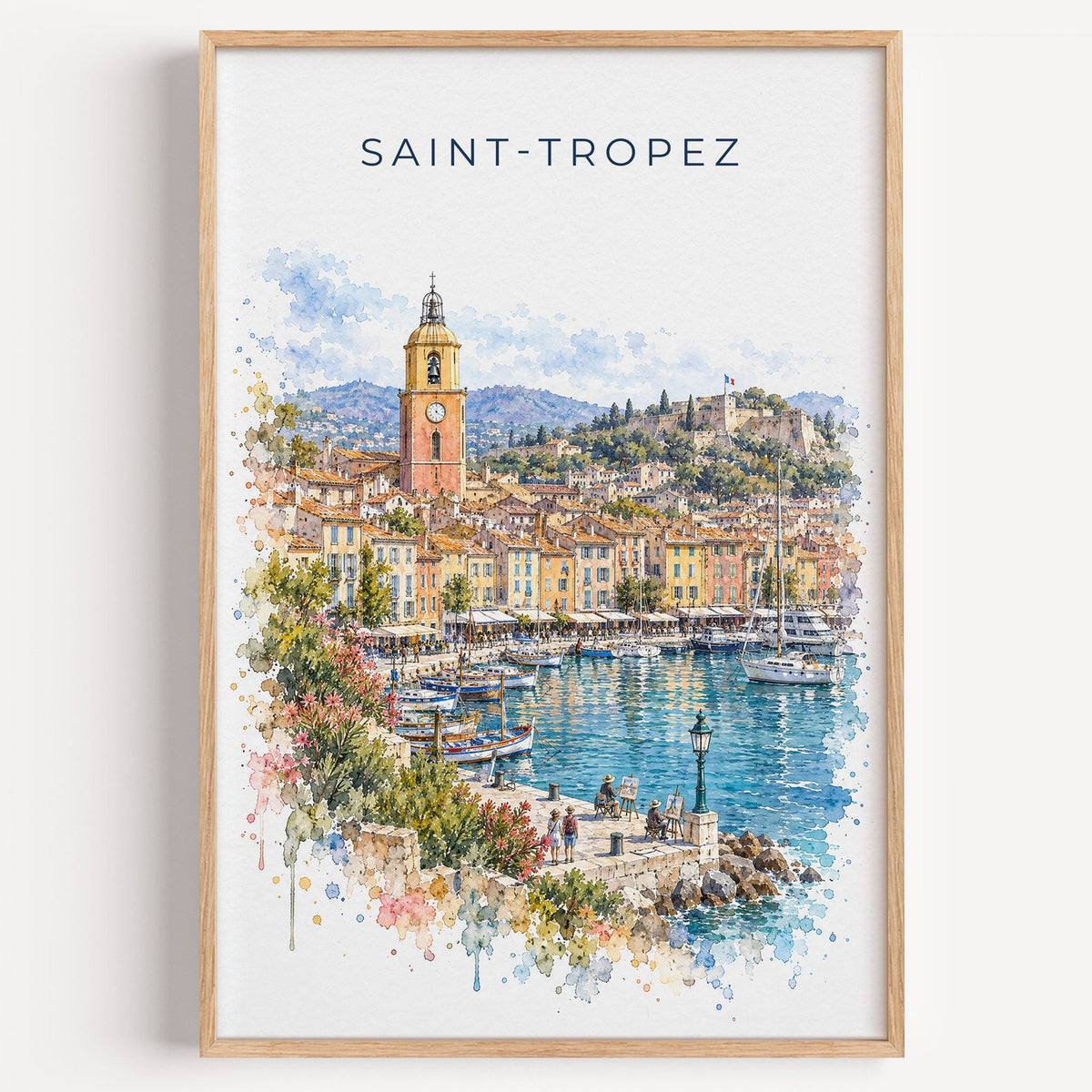 Saint-Tropez watercolor print in a light oak frame on a plain white wall
